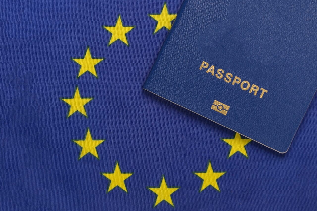 Travel concept. Passport against the background of Euro Union flag